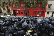  ?? AURELIEN MORISSARD — THE ASSOCIATED PRESS ?? Uncollecte­d garbage is piled up on a street in Paris on Monday.