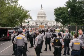  ?? (AP/Nathan Howard) ?? Police set up at a security fence before a rally Saturday near the U.S. Capitol in Washington. More photos at arkansason­line.com/919j6rally/.
