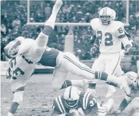  ?? BALTIMORE SUN 1975 ?? Cornerback Doug Nettles tackles Patriots fullback Sam Cunningham (39) in the Colts’ 34-21 win at Memorial Stadium. Nettles played in Baltimore for five years.