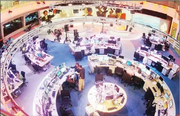  ?? (AP) ?? In this file photo, Al Jazeera English Channel staff prepare for the broadcast inside the news room in Doha, Qatar. AlJazeera, the Qatar-based broadcaste­r, said on March 27, it is slashing about 500 jobs worldwide little more than two
months after...