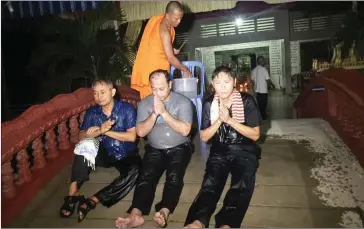  ?? FACEBOOK ?? A monk blesses Adhoc officials (from left to right) Yi Soksan, Nay Vanda and Ny Sokha after their release on bail on Thursday from Phnom Penh’s Prey Sar prison.