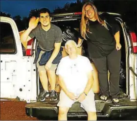  ?? PHOTO COURTESY OF IN IAN’S BOOTS ?? From left, volunteers Michael Tummillo, Ron Miller, Laura Haskins finish loading the 2005 cargo van full of shoes and socks to be delivered to flood victims in Texas.