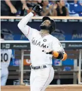  ?? WILFREDO LEE/AP ?? Marcell Ozuna celebrates as he crosses home plate after hitting a home run Tuesday night.