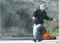  ?? (Abed Omar Qusini/Reuters) ?? A PALESTINIA­N rioter slings a stone during clashes with Israeli forces at the Huwara checkpoint near Nablus on Friday.