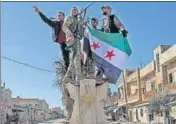  ?? AFP ?? Turkey-backed Syrian fighters celebrate in the town of Saraqib .