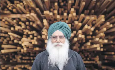  ?? DARRYL DYCK, CANADIAN PRESS ?? Mill worker Rulda Singh Gill stands in front of stacks of freshly cut wood at Partap Forest Products in Maple Ridge. Natural Resources Minister Jim Carr said the federal government will do what it can to contain job losses.