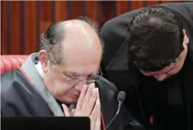  ??  ?? BRASILIA: Supreme Electoral Court (TSE) President Judge Gilmar Mendes (left), gestures during a session examining whether the 2014 reelection of president Dilma Rousseff and her then-vice president Temer should be invalidate­d because of corrupt...
