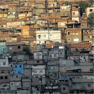  ?? Picture: BLOOMBERG ?? Buildings stand cheek by jowl in a favela in Rio de Janeiro. Brazil’s economic growth has slowed to its weakest three-year pace in a decade, advancing just 2% on average from 2011 through 2013, and its wealth distributi­on remains among the most unequal...