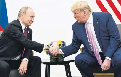  ?? BRENDAN SMIALOWSKI AFP VIA GETTY IMAGES ?? U.S. President Donald Trump, pictured with Russia President Vladimir Putin, made a plea in July 2016 to a foreign power to hack Hillary Clinton’s emails — “Russia, if you’re listening” — which summed up much that was to come.