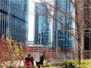  ?? Carl Nolte/The Chronicle ?? Salesforce Park is like a separate San Francisco with an older version of the city visible in the distance. Four stories above the street and four blocks long, Salesforce Park is open to everyone during the daytime.