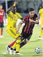  ?? [DOUGLAS DEFELICE/USA TODAY SPORTS] ?? The Crew’s Harrison Afful tackles Atlanta United’s Gonzalo Martinez during Tuesday’s game.