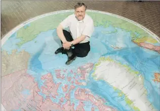  ?? POSTMEDIA NEWS FILES ?? Scientist Dr. Jacob Verhoef sits on a map of the arctic displayed at the Bedford Institute of Oceanograp­hy in Dartmouth, N. S. He says new research helps bolster Canada’s claims.