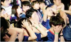  ??  ?? Japanese fans react with dismay as their team crash out of the World Cup after Belgium scored in the dying seconds of the game. - AFP photo