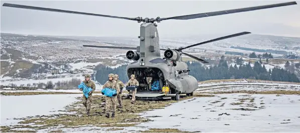  ??  ?? RAF Chinooks were drafted in to fly emergency provisions and medicines to various remote locations in Cumbria including Nenthead, above