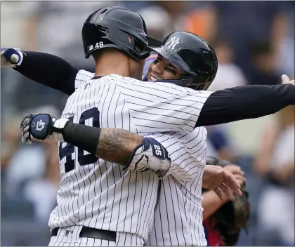  ?? JOHN MINCHILLO — THE ASSOCIATED PRESS ?? Yankees’ Gleyber Torres, right, celebrates with Josh Donaldson (48) after hitting a three-run home run off Toronto Blue Jays starting pitcher Jose Berrios (17) during Wednesday’s game.