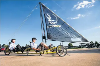  ?? Brett Coomer / Houston Chronicle ?? John MacTaggart, right, gives a ride on a Pterosail Twin to Thomas Davis during a demonstrat­ion run.