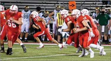  ?? PILOT PHOTO/MAGGIE NIXON ?? Plymouth QB Jake Reichard handles the keeper while Quentin Crawford (4) and Collin Mills (8) run alongside him and Devantae Garcia (13) and Owen Bockman (66) make holes.