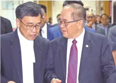  ?? — Photos by Muhammad Rais Sanusi ?? Uggah (right) in discussion with his lawyer Sim Hui Chiang.