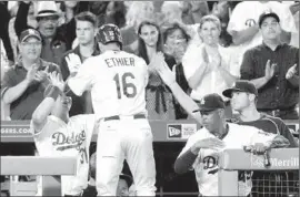  ?? Lawrence K. Ho
Los Angeles Times ?? ANDRE ETHIER gets a high-five from Joc Pederson, left, as he’s greeted in the dugout after his homer in the sixth inning gave the Dodgers a 4-3 lead.