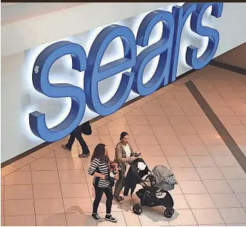  ?? SCOTT OLSON, GETTY IMAGES ?? People shop at a Sears in Schaumburg, Ill. Sears Holdings, the parent of Kmart and Sears, says there is “substantia­l doubt” about the company’s financial viability.