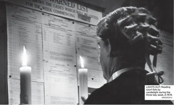  ?? MIRRIROPIX ?? LIGHTS OUT: Reading court lists by candleligh­t during the three-day week, in 1974