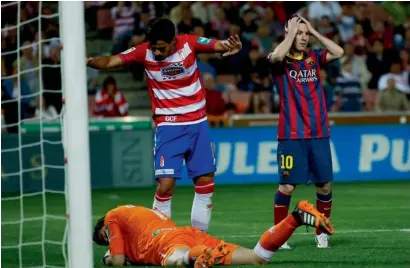  ?? Reuters ?? Barcelona’s Lionel Messi reacts after missing a scoring opportunit­y against Granada. —