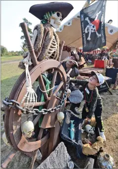  ?? Dan Watson/The Signal ?? Roman Gumm, 5, examines the ship wheel and pirate skeleton fourth annual SCV Brewmaster­s Pirate Beer Festival Saturday. at the