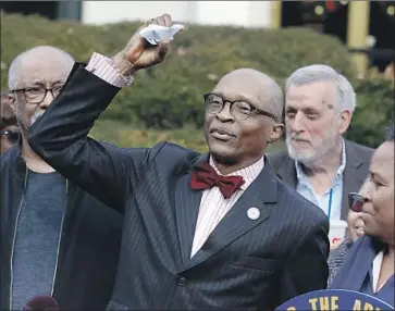  ?? Ethan Hyman News & Observer ?? AT A NEWS CONFERENCE on Friday, the Rev. Anthony Spearman, president of the North Carolina chapter of the NAACP, crumples up a mailer informing voters that photo IDs will be required in the 2020 election.