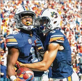  ?? MICHAEL CHANG / GETTY IMAGES ?? Auburn receiver Seth Williams celebrates with receiver Anthony Schwartz after scoring the winning touchdown against Texas A&amp;M this past Saturday. It was the Tigers’ second consecutiv­e win.