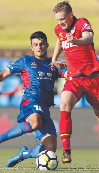  ?? Picture: DARREN PATEMAN ?? John Koutroumbi­s (left) arrives on the scene for the Newcastle Jets to challenge Adelaide United rival Ryan Kitto during yesterday’s A-League clash at McDonald Jones Stadium