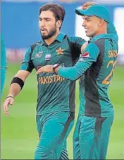  ?? AP ?? Pakistan's Usman Khan (left) celebrates with teammate Shadab Khan the dismissal of Hong Kong's Tanvir Afzal.