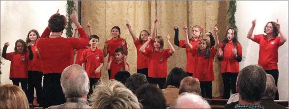  ?? MEGAN DAVIS MCDONALD COUNTY PRESS ?? AMBER NELSON AND THE MCDONALD COUNTY CHILDREN’S CHOIR entertaine­d the audience with cheery Christmas numbers. The goal of MCCC is to uplift God and country through children’s
voices.