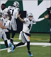  ?? BILL KOSTROUN — THE ASSOCIATED PRESS ?? Las Vegas quarterbac­k Derek Carr celebrates his winning touchdown pass to Henry Ruggs III in the final seconds.
