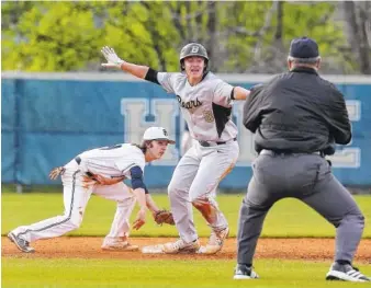  ?? STAFF PHOTOS BY ERIN O. SMITH ?? Bradley Central’s Luke Ellis indicates to the umpire that he believes he is safe after Soddy-Daisy second baseman Jacob Jennings briefly pulled away from the bag to reach the ball during the first game of a doublehead­er between the two schools...