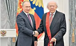  ??  ?? Rozhdestve­nsky in action, and receiving a medal from President Putin in 2017: in Soviet times he trod a careful path and was a ‘not-quite dissident’