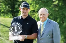  ?? — AFP photo ?? Patrick Cantlay (le ) poses with Jack Nicklaus and the trophy a er winning The Memorial Tournament Presented by Nationwide at Muirfield Village Golf Club in Dublin, Ohio in this June 2, 2019 file photo.