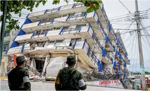  ?? AFP ?? Soldiers stand guard a few metres away from the Sensacion hotel which collapsed with the powerful earthquake that struck Mexico overnight, in Matias Romero, Oaxaca State. —