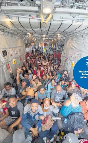  ?? Photos / NZDF ?? Survivors from Palu give a thumbs up sign before the Royal New Zealand Air Force C-130 Hercules aircraft took off yesterday.