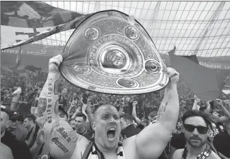  ?? REUTERS ?? Bayer Leverkusen fans celebrate in the stands after their team defeated Werder Bremen 5-0 to claim the German Bundesliga title on Sunday.