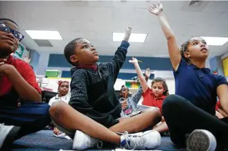  ?? Michael Ciaglo / Houston Chronicle ?? Nine-year-old Antwon Patrick, center, is one of 20 students at Outley Elementary who started attending the school after being displaced by Hurricane Harvey.