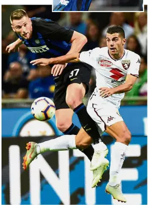  ??  ?? Tough defending: Inter Milan's Milan Skriniar (left) and Torino's Iago Falque vying for the ball in the Serie A match at San Siro on Sunday. Inset: Inter's Ivan Perisic celebratin­g after scoring their opening goal. — AFP