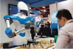  ??  ?? TAIPEI: A visitor plays go with a robot designed by Taiwan’s Industrial Technology Research Institute (ITRI) during the Computex Show in Taipei yesterday —AFP