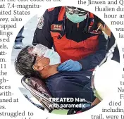  ?? ?? TREATED Man with paramedic