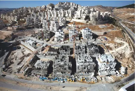  ?? (Reuters) ?? HOUSES UNDER constructi­on in Har Homa.