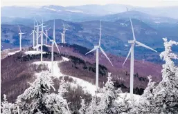  ?? ROBERT F. BUKATY/AP ?? Expansion of renewable energy in the U.S. is one of President Biden’s goals. Above, turbines are seen Feb. 6 atop Saddleback Wind Mountain in Carthage, Maine.