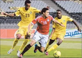  ?? AFP/Getty Images ?? A GAME WITHOUT FANS “has no soul,” Bob Bradley said of a match his Egyptian team, including Mohamed “Gedo” Nagy (15), played before empty stands.