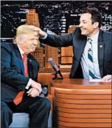  ?? ANDREW LIPOVSKY/NBC ?? Jimmy Fallon ruffles the hair of then-candidate Donald Trump in 2016. Fallon took heat for softball questions.