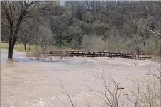  ?? Bennett Horne/The Weekly Vista ?? High water reached the No. 18 bridge at Kingswood Golf Course following the rainstorms that moved through Bella Vista last week.