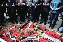  ?? — AFP ?? Mayors of main opposition People’s Republic Party (CHP) pray after laying wreaths in front of the Reina nightclub on Wednesday in Istanbul.