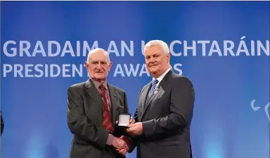  ??  ?? Jackie Napier of Bray Emmets is presented with the Leinster Award, by Uachtarán Chumann Lúthchleas Gael Aogán Ó Fearghail during the GAA President’s Awards 2017 at Croke Park in Dublin. Photo: Eóin Noonan/Sportsfile